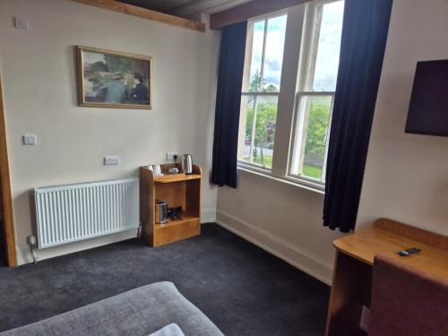 a room with a bed and a window at Bank House in Inverness