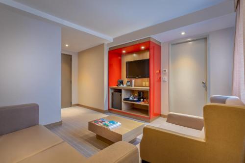 a living room with a red cabinet and a tv at InterContinental São Paulo by IHG in Sao Paulo