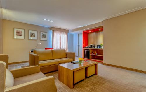 a living room with a couch and a coffee table at InterContinental São Paulo by IHG in Sao Paulo