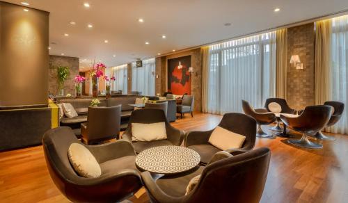 a lobby with chairs and a table and a salon at InterContinental São Paulo by IHG in Sao Paulo