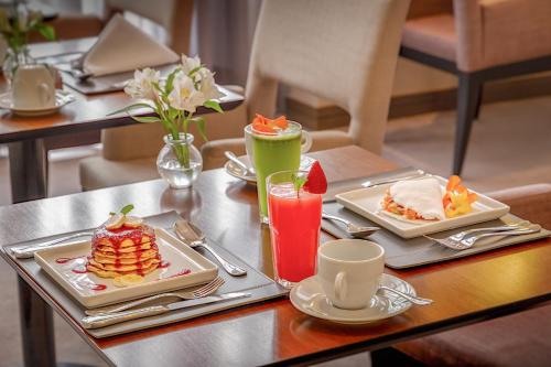 a table with two plates of food and drinks on it at InterContinental São Paulo by IHG in Sao Paulo