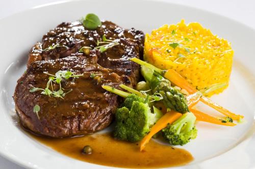 a plate of food with steak and vegetables on it at InterContinental São Paulo by IHG in Sao Paulo