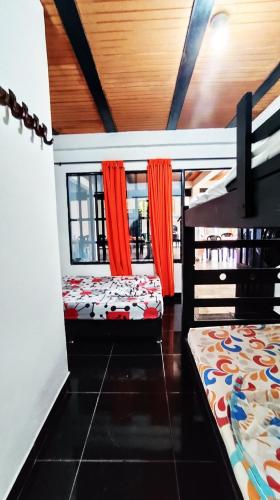 a room with two bunk beds and a window at Finca la Campechana in Restrepo