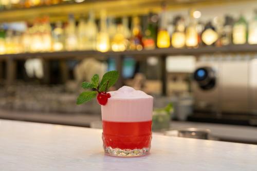 a drink with a strawberry on the counter of a bar at InterContinental São Paulo by IHG in Sao Paulo