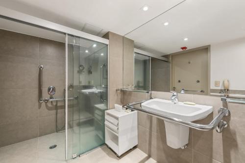 a bathroom with a sink and a shower at InterContinental São Paulo by IHG in Sao Paulo