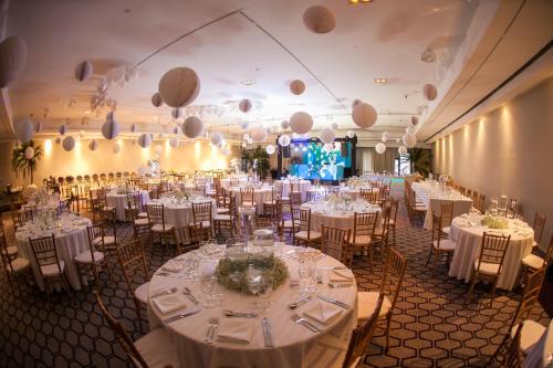 a banquet hall with white tables and chairs at InterContinental São Paulo by IHG in Sao Paulo