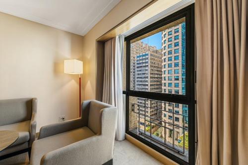 a room with a window with a view of a city at InterContinental São Paulo by IHG in Sao Paulo