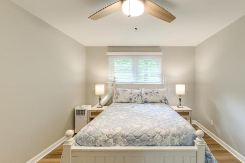 a bedroom with a bed and a ceiling fan at Alleghany Mountain Cottage with Porch and Backyard in Covington