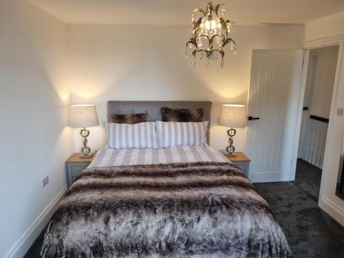 a bedroom with a large bed with two lamps at 3 Bedroom House By The Sea, Deal Centre in Deal
