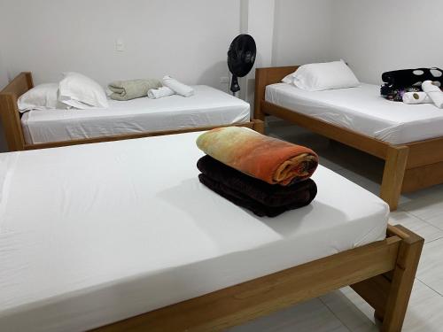 a room with two beds with towels on them at HOTEL LA SELVA JARDIN in Jardin