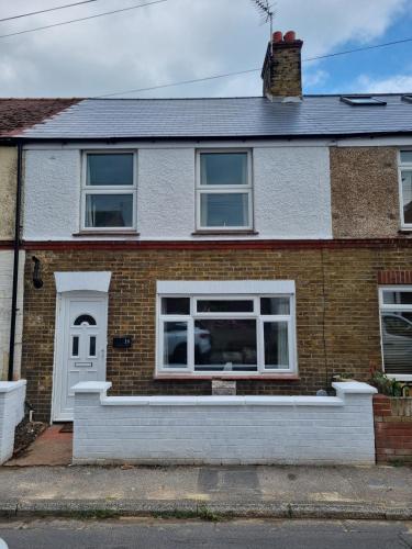 a brick house with a white door and windows at 3 Bedroom House By The Sea, Deal Centre in Deal
