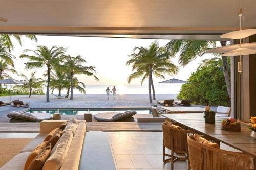a living room with a view of the beach at The Ritz-Carlton Maldives, Fari Islands in North Male Atoll