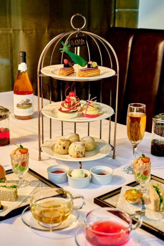 a table with a plate of food and glasses of wine at Sheraton Grand Hotel & Spa in Edinburgh