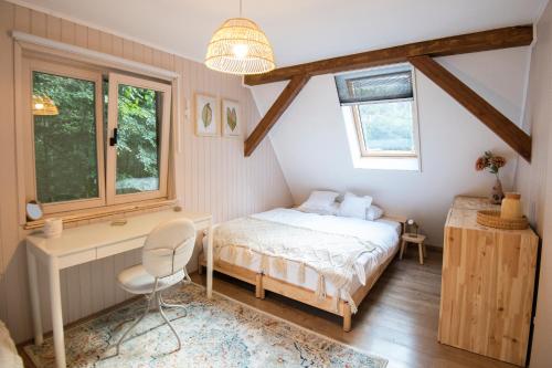 a bedroom with a bed and a desk and window at Forest Cabin Nest-Family Retreat for 7 with Sauna & Hot tub in Gornji Mihaljevec