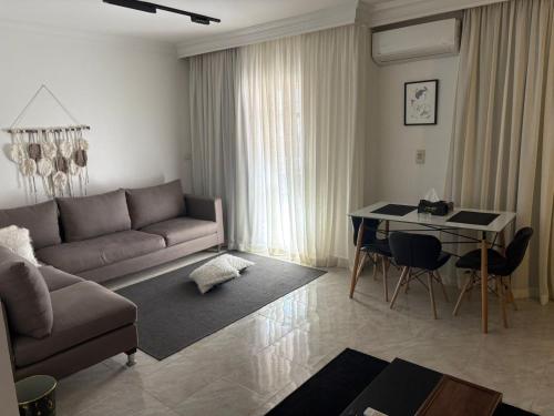 a living room with a couch and a table at Distinguished flat at Madinaty - View south park direct 300 m from down town in Madinaty