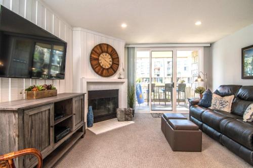 a living room with a couch and a fireplace at Walk to the Beach Balcony Sunset Ocean Views in Oceanside