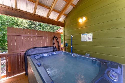 a jacuzzi tub in a green building at Wildflower Cabin with a private hot tub in Bryant
