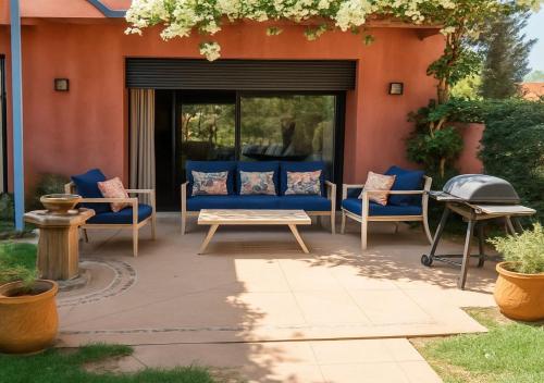 a patio with blue chairs and a table at Vizir 301 in Marrakech