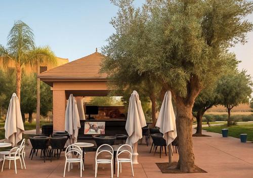 a group of tables and chairs with white umbrellas at Vizir 301 in Marrakech
