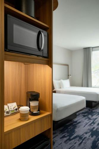 a hotel room with a bed and a flat screen tv at Fairfield by Marriott Inn & Suites Lancaster in Lancaster