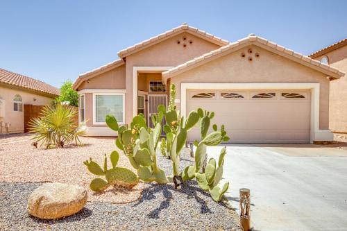 a cactus in front of a house with a garage at Fenced-In Pool and Patio Gilbert Home! in Gilbert