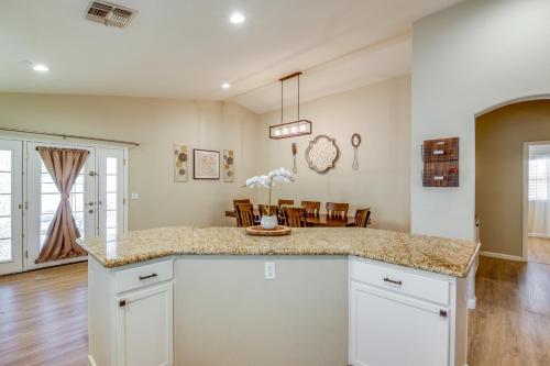 a kitchen with a counter and a dining room at Fenced-In Pool and Patio Gilbert Home! in Gilbert