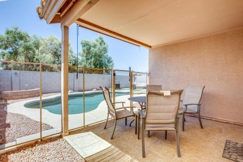 a patio with a table and chairs and a pool at Fenced-In Pool and Patio Gilbert Home! in Gilbert