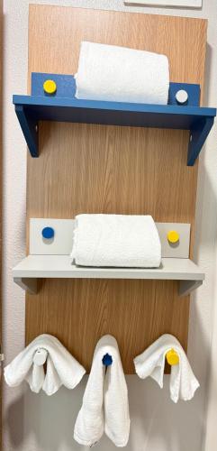 a towel rack with towels on a wall at Microtel Inn & Suites by Wyndham Sioux Falls in Sioux Falls