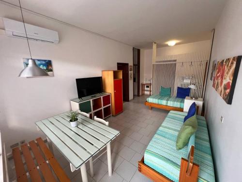 a living room with a couch and a table at Residence Casa Pineta in Principina a Mare