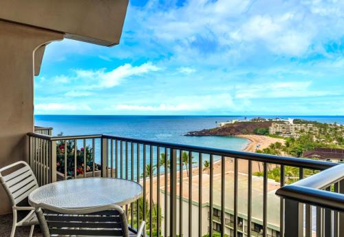 a balcony with a table and chairs and the ocean at KBM Resorts FREE CAR The Whaler Ocean view Studio with Stunning Sunset WH1-1218 in Kaanapali