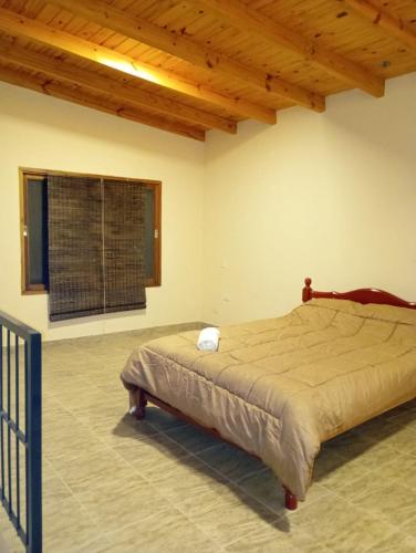 a bedroom with a bed in a room with a wooden ceiling at Luna Cautiva in Cafayate