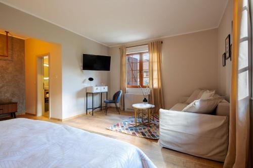 a bedroom with a bed and a living room at Plitvice Village in Korenica