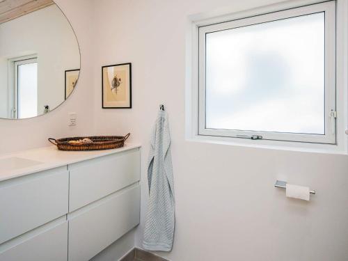 a bathroom with a mirror and a sink at 4 star holiday home in Blokhus-By Traum in Blokhus