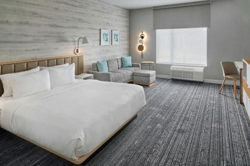 a hotel room with a bed and a chair at TownePlace Suites by Marriott Calhoun in Calhoun