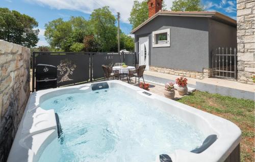 a hot tub in the backyard of a house at Stunning Home In Umag With Wifi in Umag