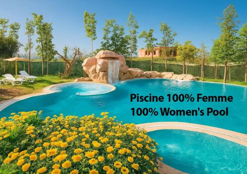a pool with a waterfall and flowers in a yard at Appart Vizir center 225 in Marrakech