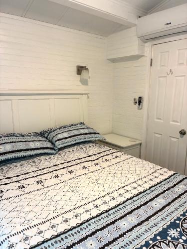a bedroom with a bed and a white door at River Run Cottage Modern 2BR Waterfront Retreat in Linville Land Harbor in Newland