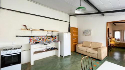 a living room with a stove and a couch at Catavento Pousada in Alto Paraíso de Goiás