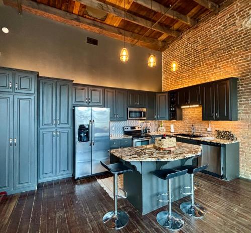 a kitchen with blue cabinets and a refrigerator at In the Heart of Town-3BR-2bath-500Mbps WiFi-4car parking-EV-boat in Florence