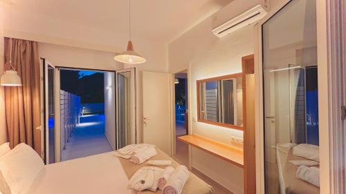 a hotel room with a bed and a mirror at Zorbas Family Villas in Skiathos Town