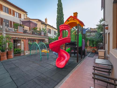 a playground with a slide in a courtyard at Hotel Mia Cara & Spa in Florence