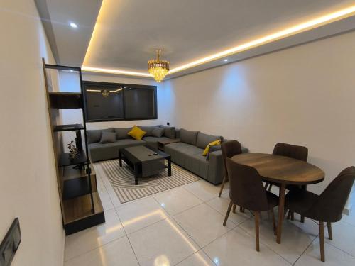 a living room with a couch and a table at Appartement moderne avec vue MER in Agadir