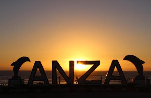 a sunset on the beach with the word akaz in front at Appartement moderne avec vue MER in Agadir
