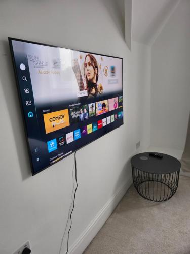 a flat screen tv hanging on a wall at Shrewsbury in Manchester