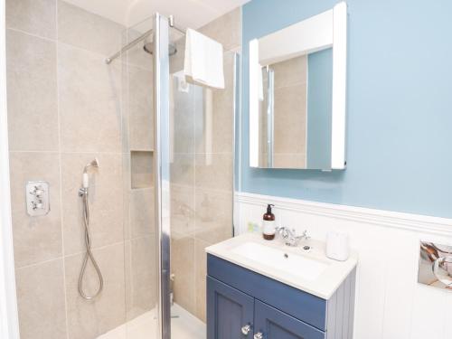 a bathroom with a sink and a shower at Milston in Ventnor