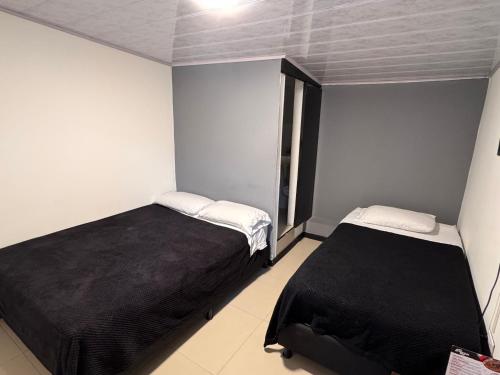 Cama o camas de una habitación en Hotel Bogotá Suites Teusaquillo