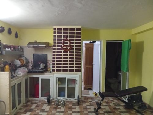 a room with a kitchen with yellow walls and a kitchen at Studio tanger,asilah in Al Houara