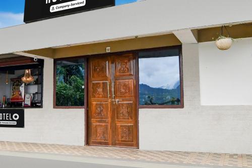 a door on a building with a view of a mountain at Hotel O Ranka Gangtok in Tādong