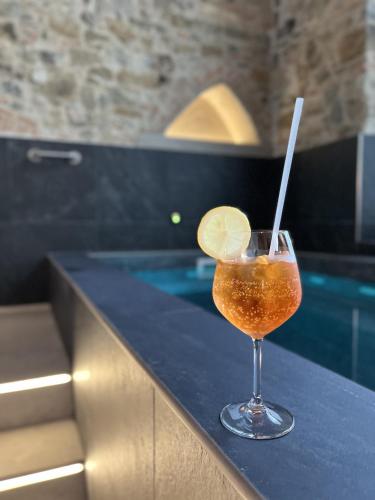 a drink sitting on a counter next to a swimming pool at Hotel Mia Cara & Spa in Florence