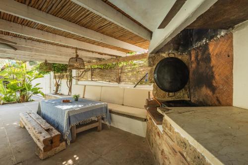 an outdoor kitchen with a table and a stove at Latidos del mar in Denia